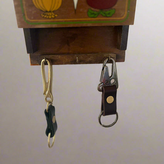 2 Keychains hanging from keyhooks.